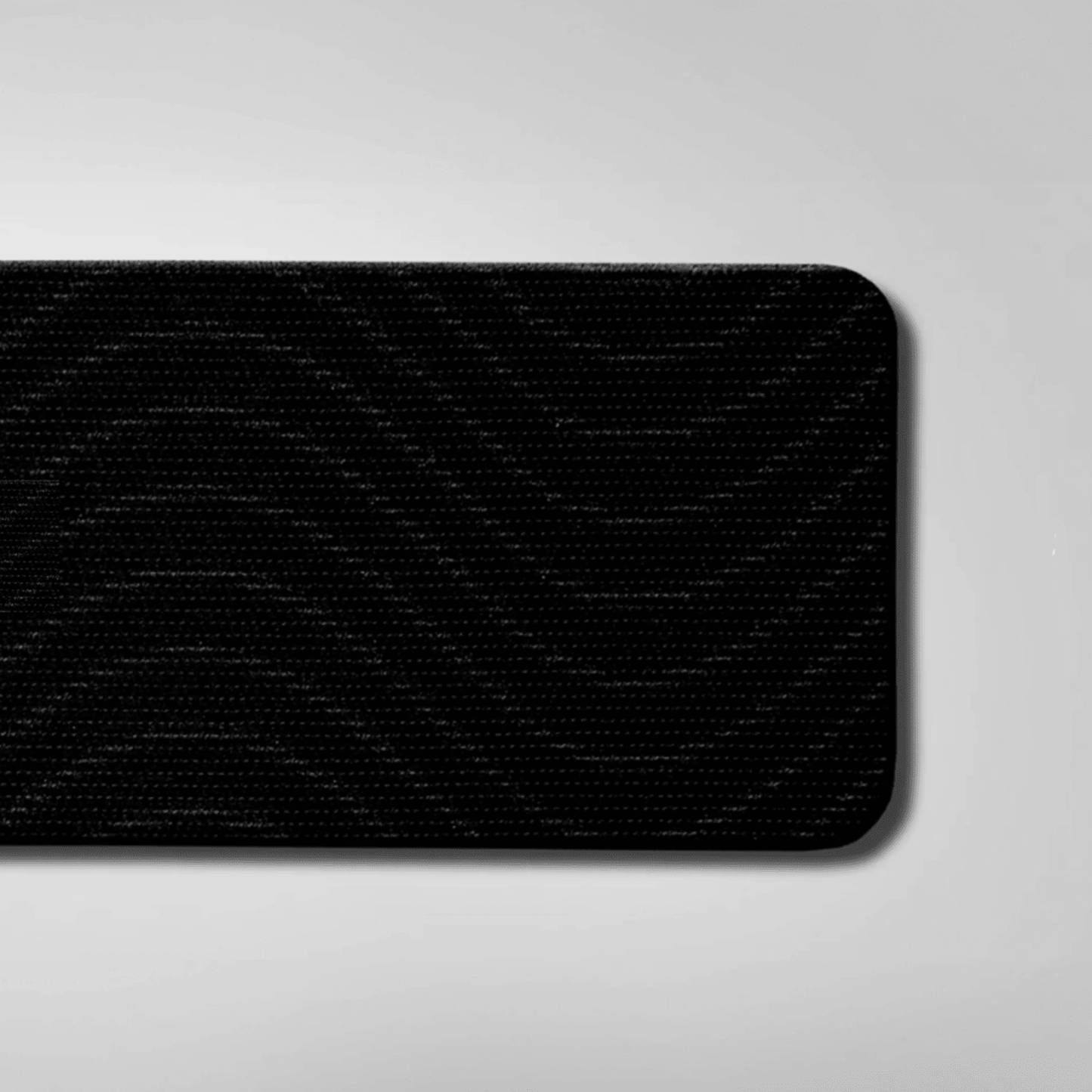 Black textured mouth tape on a gray background